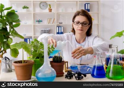 Old female biotechnology chemist working in the lab 