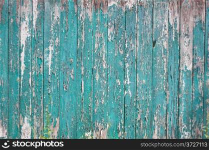 Old fence with the texture of cracked paint emerald