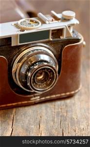 Old film camera on wooden background