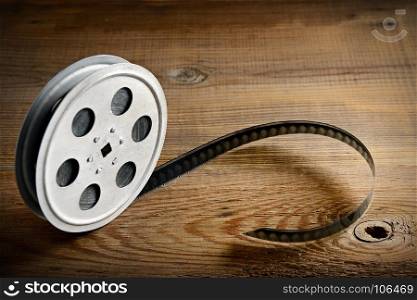 Old film strip on wooden background. Top view. Copy space.
