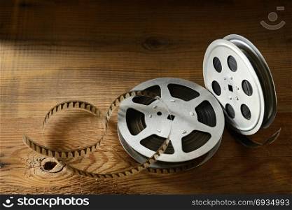 Old film strip on wooden background. Top view. Copy space for text