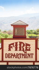 Old fire department sign painted on wood.