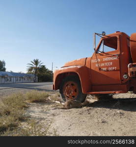 Old fire truck abandoned in desolate town.