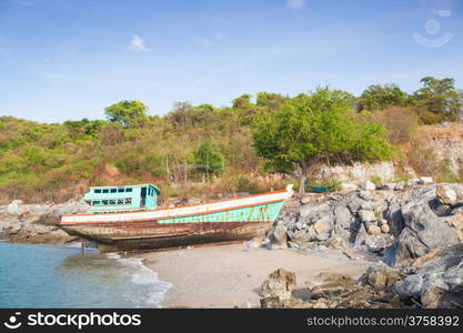 Old fishing boat on the beach. Old ships were left on the beach on the island.