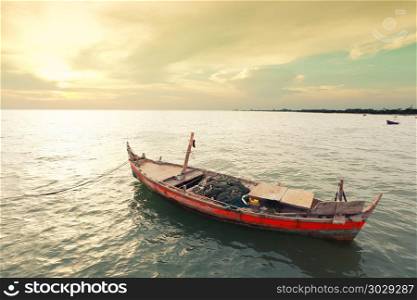 Old fishing boat on the sea coast of Thailand.. Old fishing boat on the sea coast of Thailand,concept of adventure and livelihood.