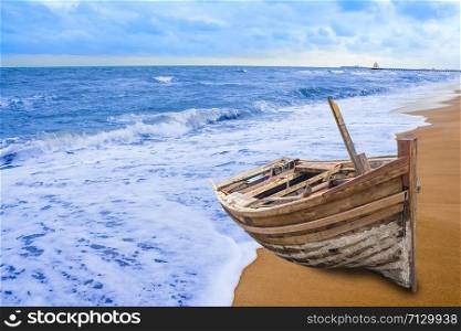Old fishing boat stranded on a beach in sunny day