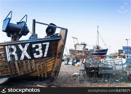 Old Fishing boats and equipment on Hastings beach landscape at d. Places. Fishing boats and equipment on Hastings beach landscape at dawn