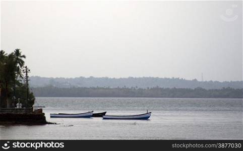 Old fishing boats at sea. India Goa.