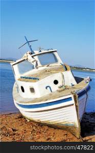 Old fishing vessel on the sea coast, Algarve, Portugal