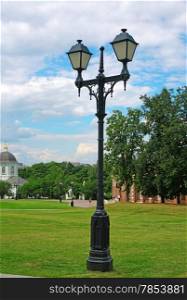 Old forged lantern in a summer park