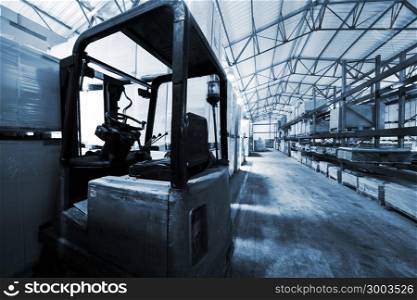 old forklift in a large modern warehouse