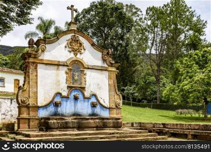 Old fountain built in the 18th century in colonial style in the historic city of Tiradentes in Minas Gerais, Brazil.. Old fountain built in the 18th century in city of Tiradentes
