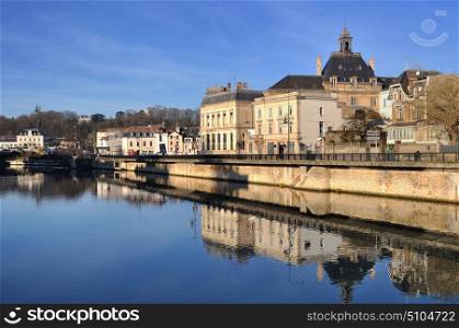 Old french city by the water with reflections