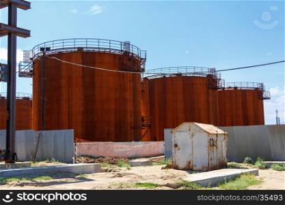 Old fuel tanks on the refinery station. Old fuel tanks in summer day