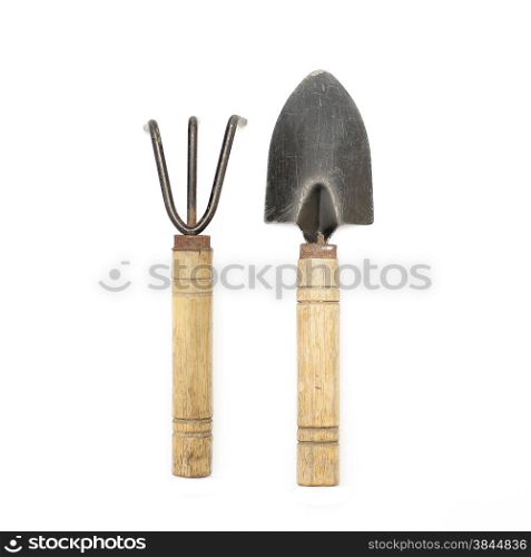 old gardening tools spade and rake isolated on white background