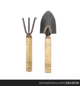 old gardening tools spade and rake isolated on white background