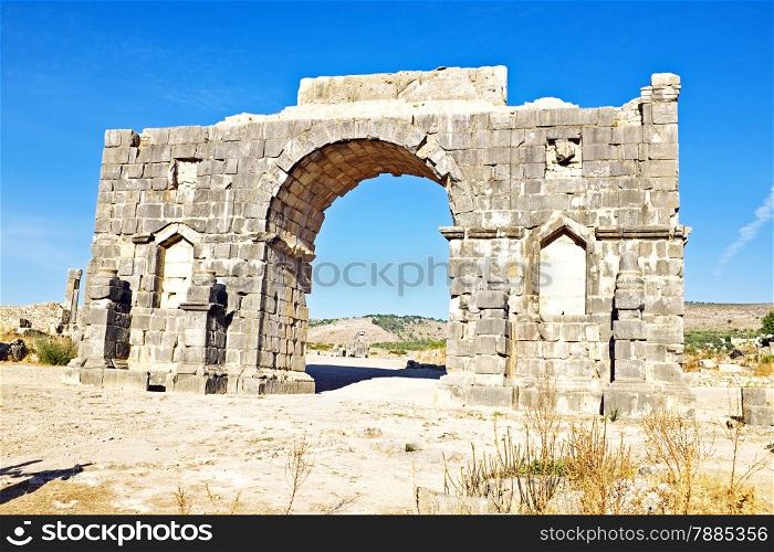 Old gate at Volubilis in Morocco. Volubilis is a partly excavated Roman city in Morocco situated near Meknes between Fes and Rabat. It was developed from the 3rd century BC onwards as a Phoenician Carthaginian settlement