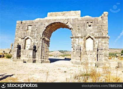 Old gate at Volubilis in Morocco. Volubilis is a partly excavated Roman city in Morocco situated near Meknes between Fes and Rabat. It was developed from the 3rd century BC onwards as a Phoenician Carthaginian settlement