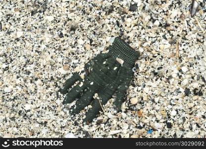 Old gloves on the sand