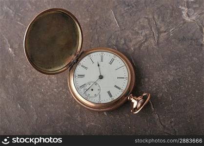 Old gold watch lie on table