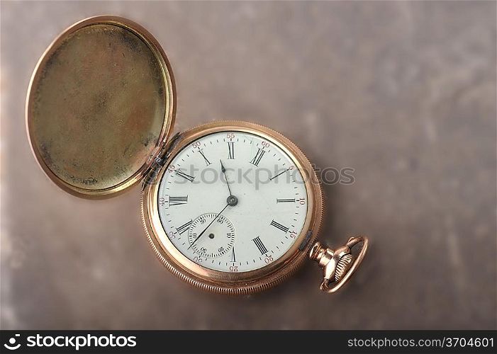 Old gold watch lie on table