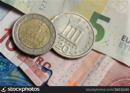Old Greek and modern greek euro coins on Euro bank notes