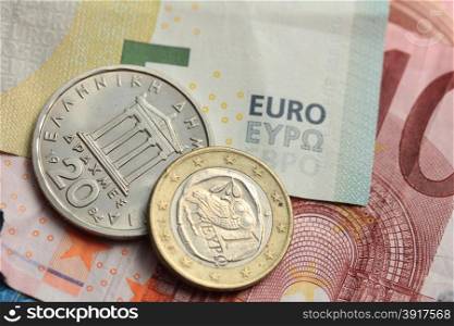 Old Greek and modern greek euro coins on Euro bank notes