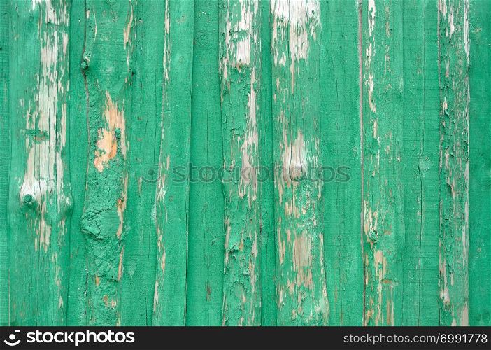 Old green wooden surface texture with peeling paint