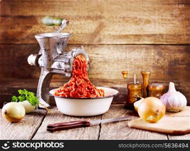 old grinder with minced meat on wooden table