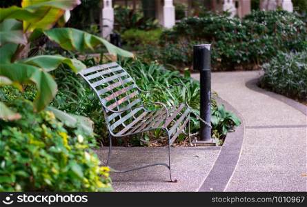 Old grunge green stainless steel bench in garden