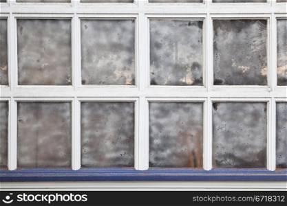 old grunge multi panel window with street reflection