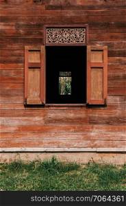 Old grunge teak wood window in old abandoned house in Phrae, Thailand