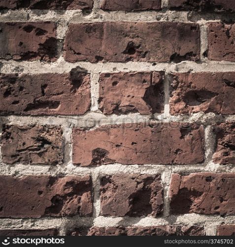 Old grungy destroyed background of a red brick wall texture