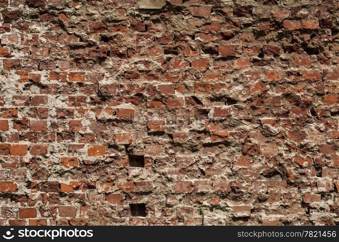 Old grungy destroyed background of a red brick wall texture