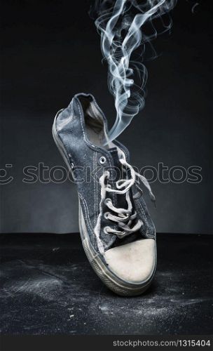 Old gym-shoe from which the smoke proceeds