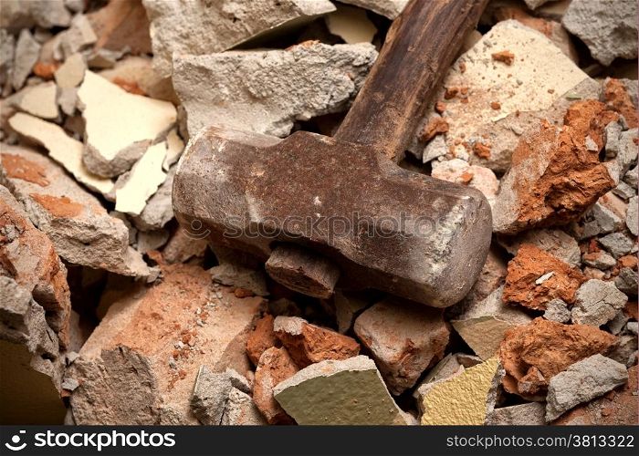 Old hammer closeup on broken brick wall