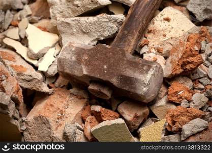 Old hammer closeup on broken brick wall