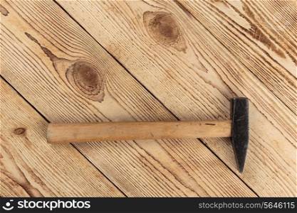 Old hammer on a wooden background. carpentry tools on a wooden background