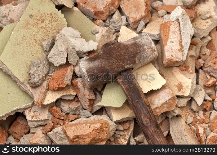 Old hammer on broken brick wall background