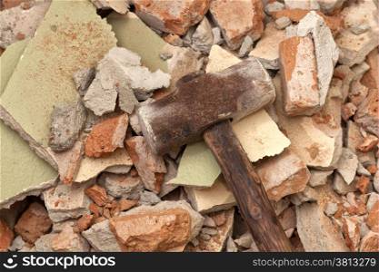 Old hammer on broken brick wall background