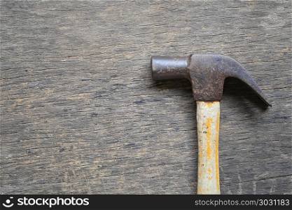Old Hammer placed on a wooden floor.. Old Hammer placed on a wooden floor and have copy space for design in your work.