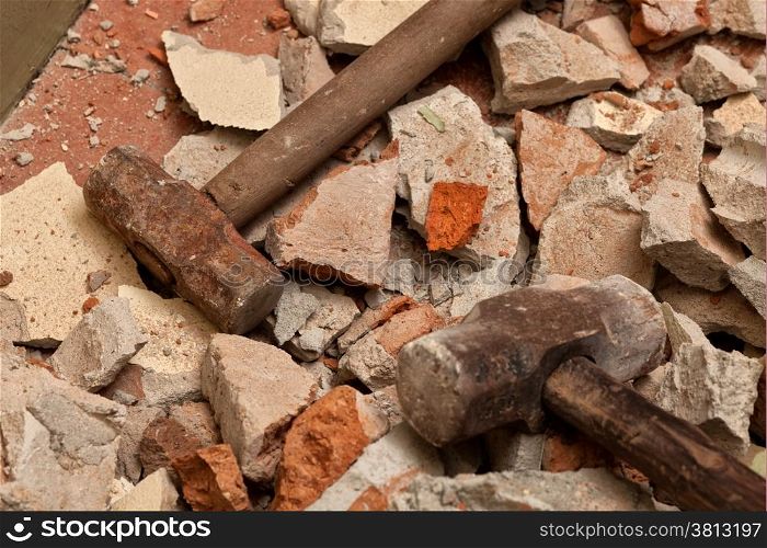 Old hammers on broken brick wall
