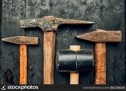 Old hammers on steel surface. Rusty tools for maintenance. Hardware tools to fix. Technical background with copy space