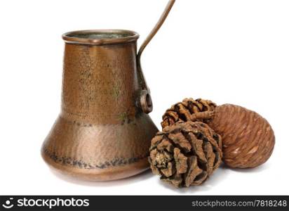 old handmade copper kettle and pine cones