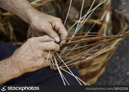 Old hands working in a basket costruction