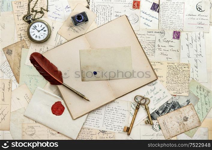 Old handwritten letters postcards. Open book and vintage tools. Romantic sentimental paper background
