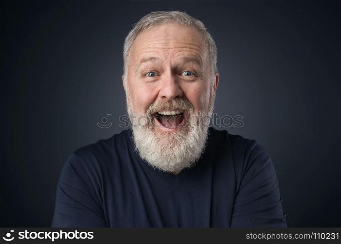 Old happy man with beard on blue background