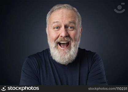 Old happy man with beard on blue background
