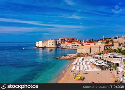 Old Harbour with Fort St Ivana and public Banje Beach in sunny day in Dubrovnik, Croatia. Old Harbor of Dubrovnik, Croatia
