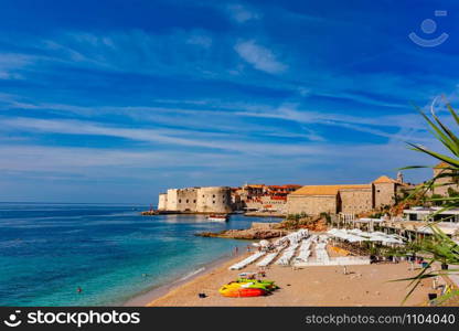 Old Harbour with Fort St Ivana and public Banje Beach in sunny day in Dubrovnik, Croatia. Old Harbor of Dubrovnik, Croatia